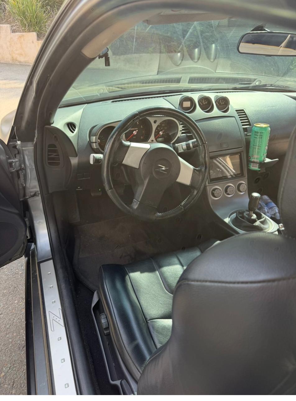 Passenger footwell before detailing — dirt and debris on carpet